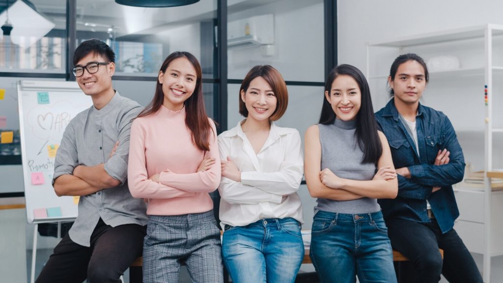 group of young asian business people standing in office | asl2axcel